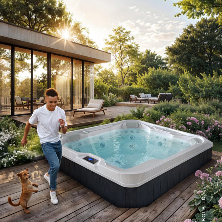 Whirlpool steht in einem schön gestalteten Garten mit Blumen und ein Junge steht mit seinem Hund daneben